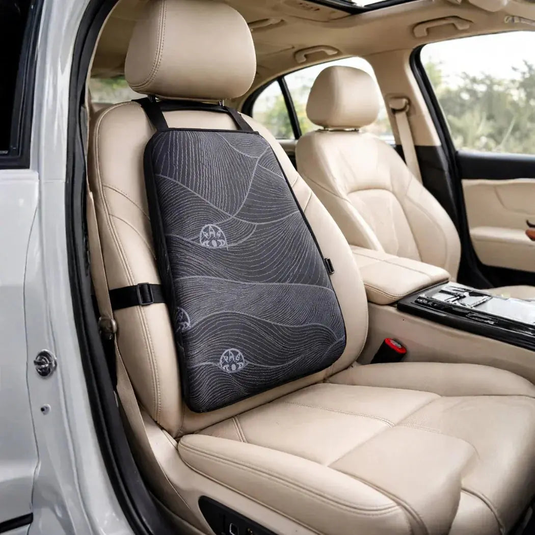 Ergonomic black back support cushion on beige car seat for posture and lumbar comfort