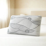 Rectangular memory foam pillow with abstract line design on bed in sunlit bedroom