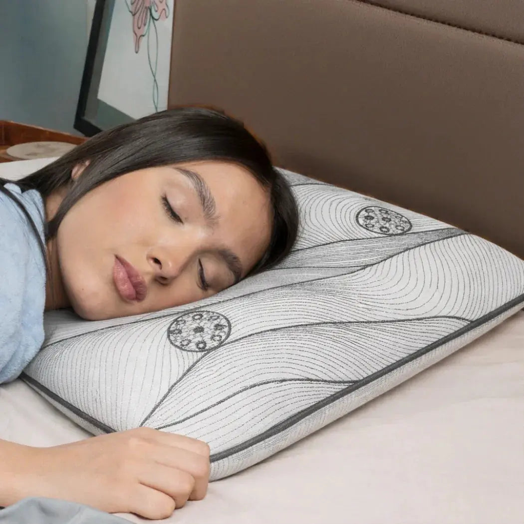 Woman sleeping on an ergonomic ultra-thin pillow with a supportive memory foam design